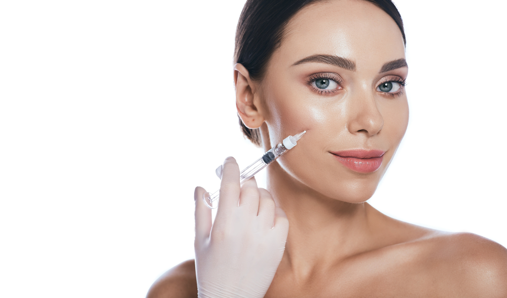 A woman receiving an injectable filler in her cheek